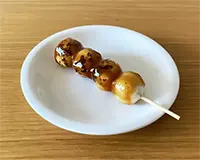 伊勢屋西川口店 | 西川口のおにぎりの甘しょっぱいみたらしのタレがかかった焼き団子の写真